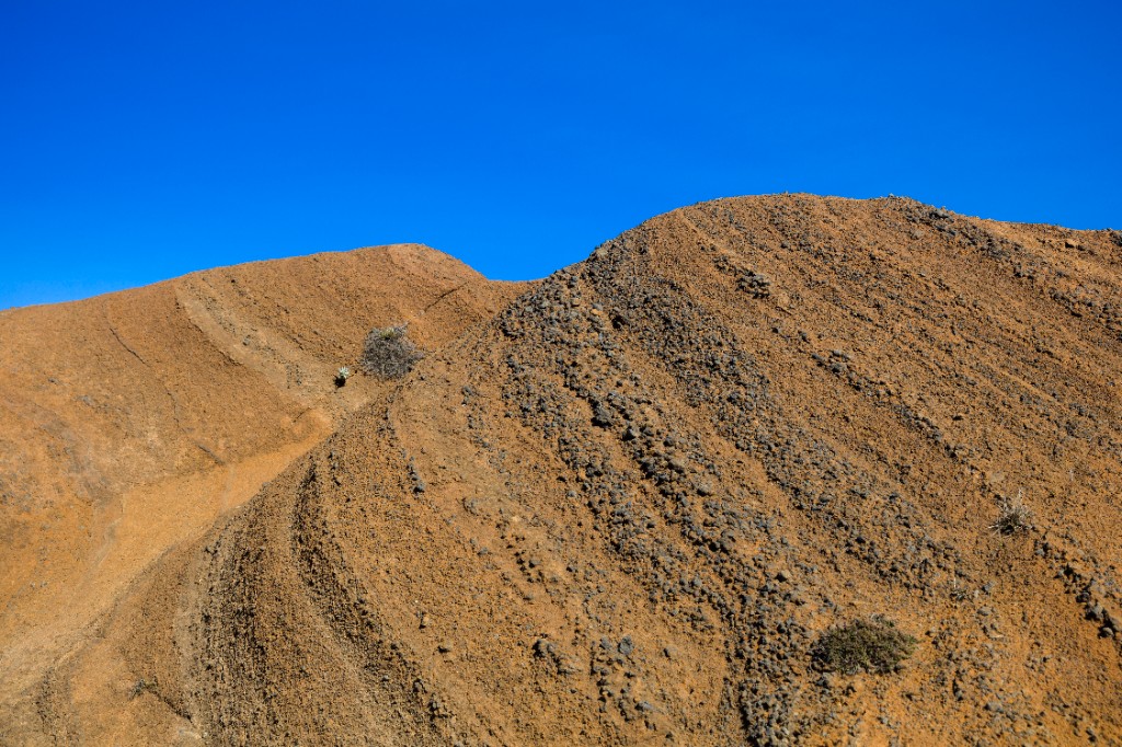 Large stockpiles of fill dirt and aggregate on site