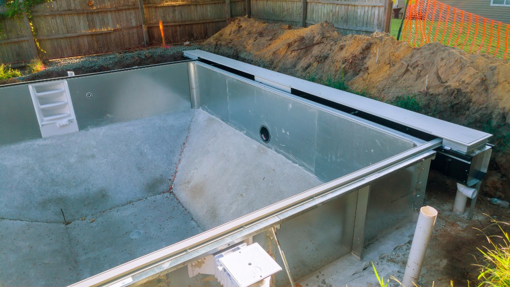 Residential pool excavation with soil ready for haul-off