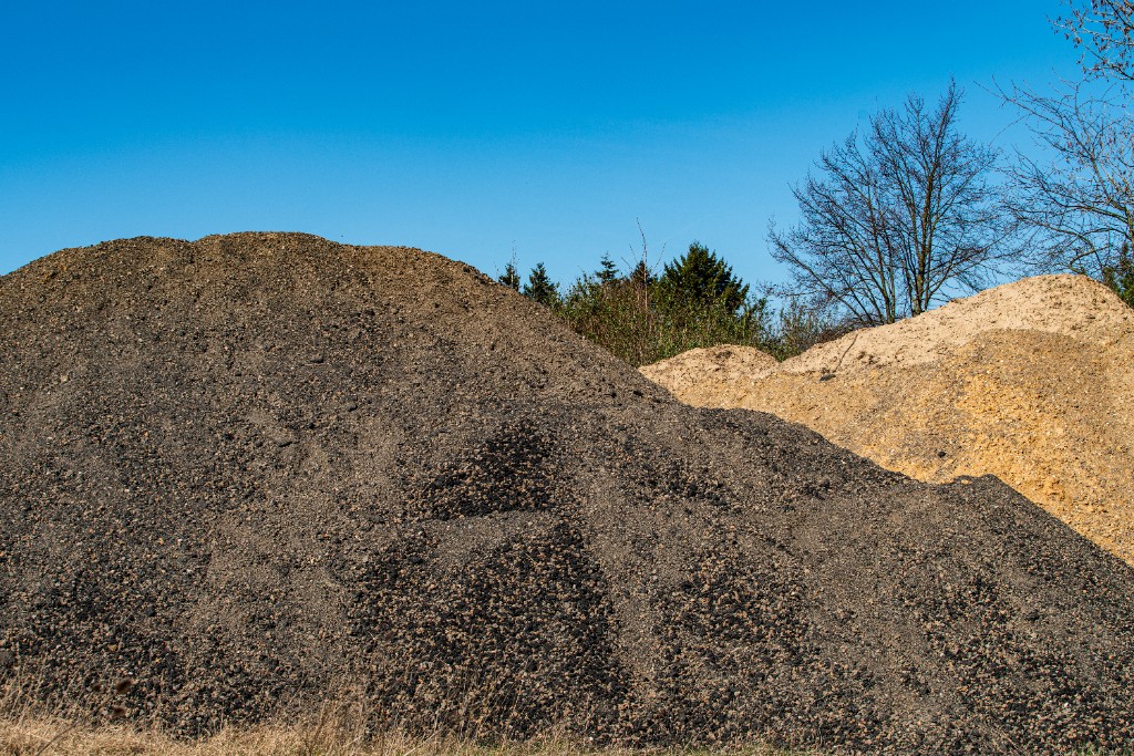 Compact track loader moving soil on a residential landscaping or prep site