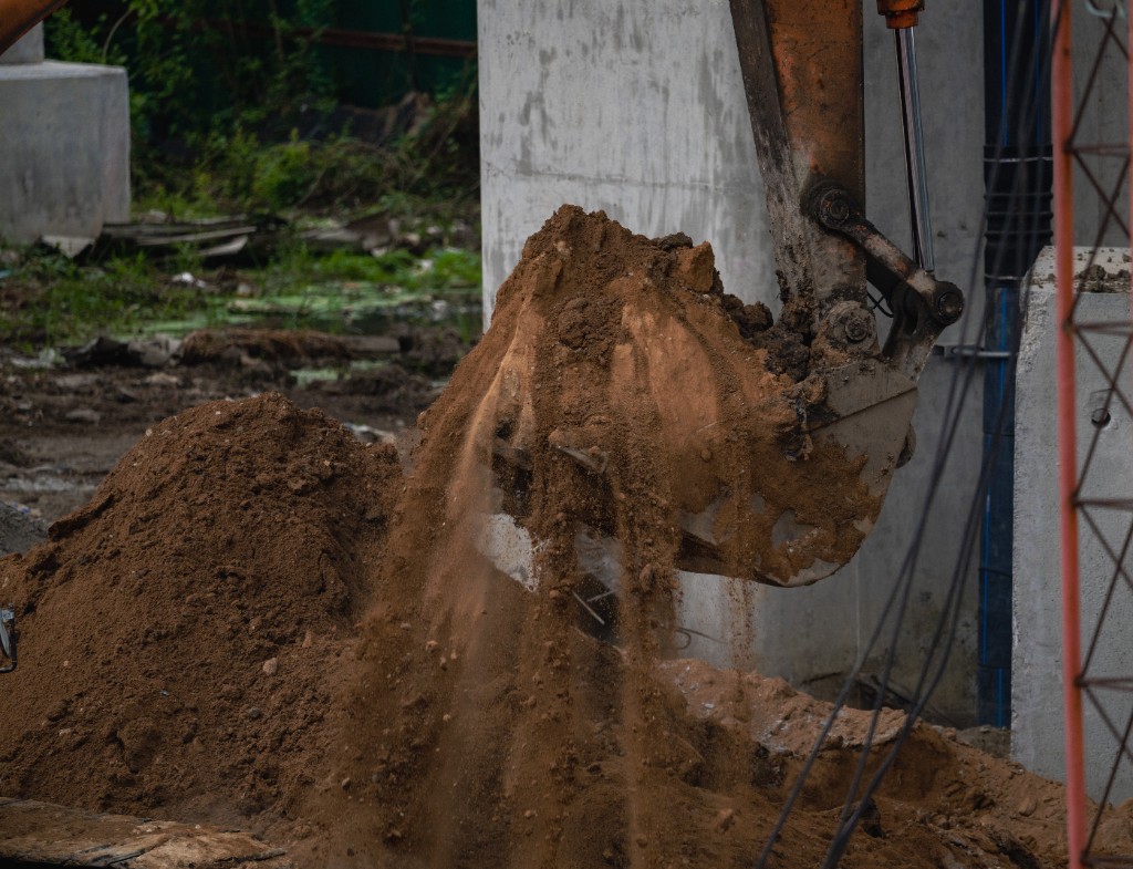 Skid steer and stockpiles during structural fill and grading